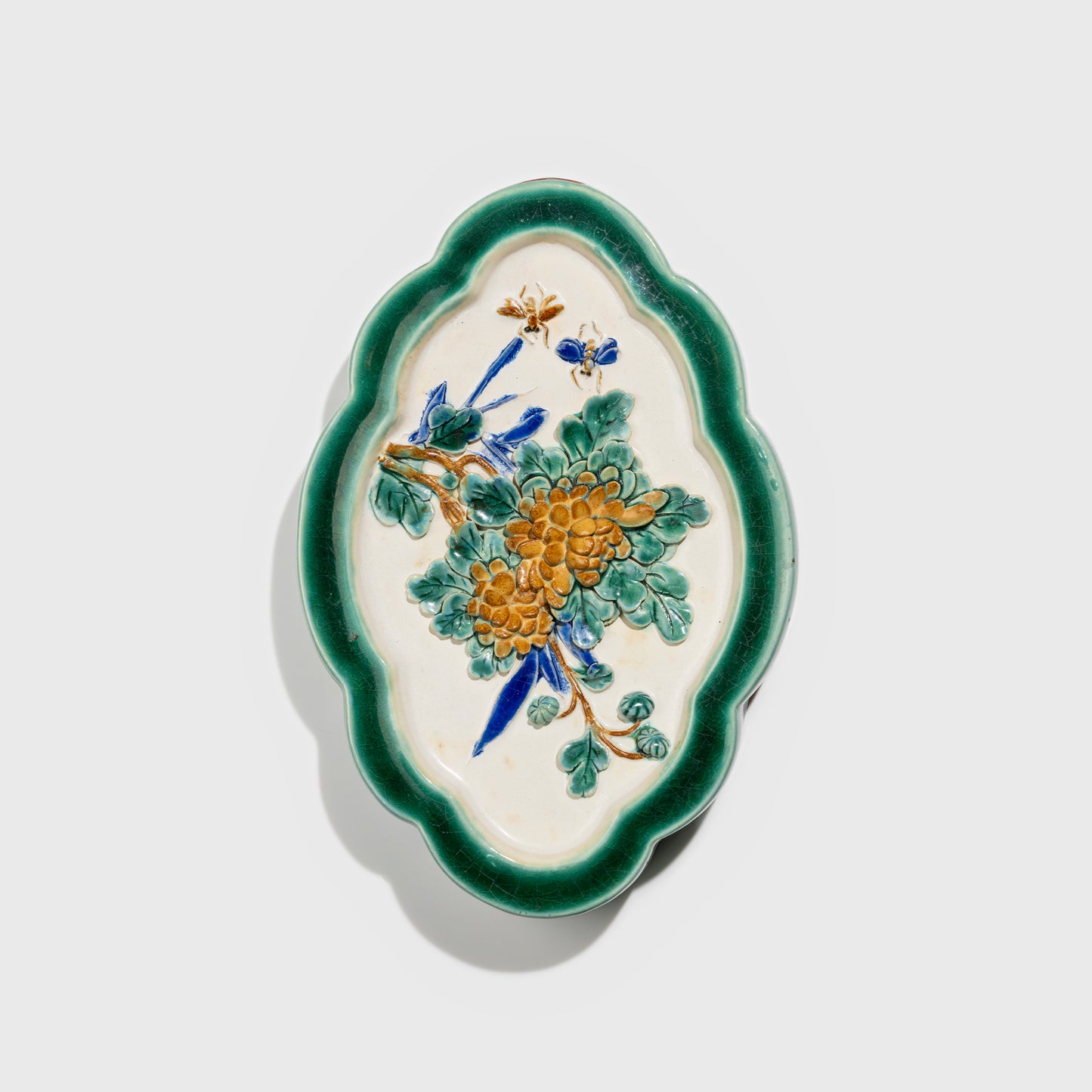 Shiwan handcrafted ceramic wall art depicting chrysanthemums, traditional Chinese hanging vase with Cantonese glaze technique.