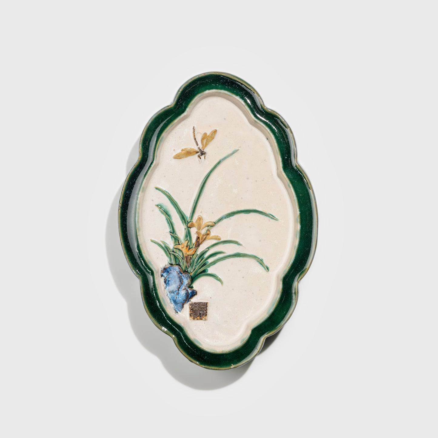 Shiwan handcrafted ceramic wall art depicting orchid, traditional Chinese hanging vase with Cantonese glaze technique.