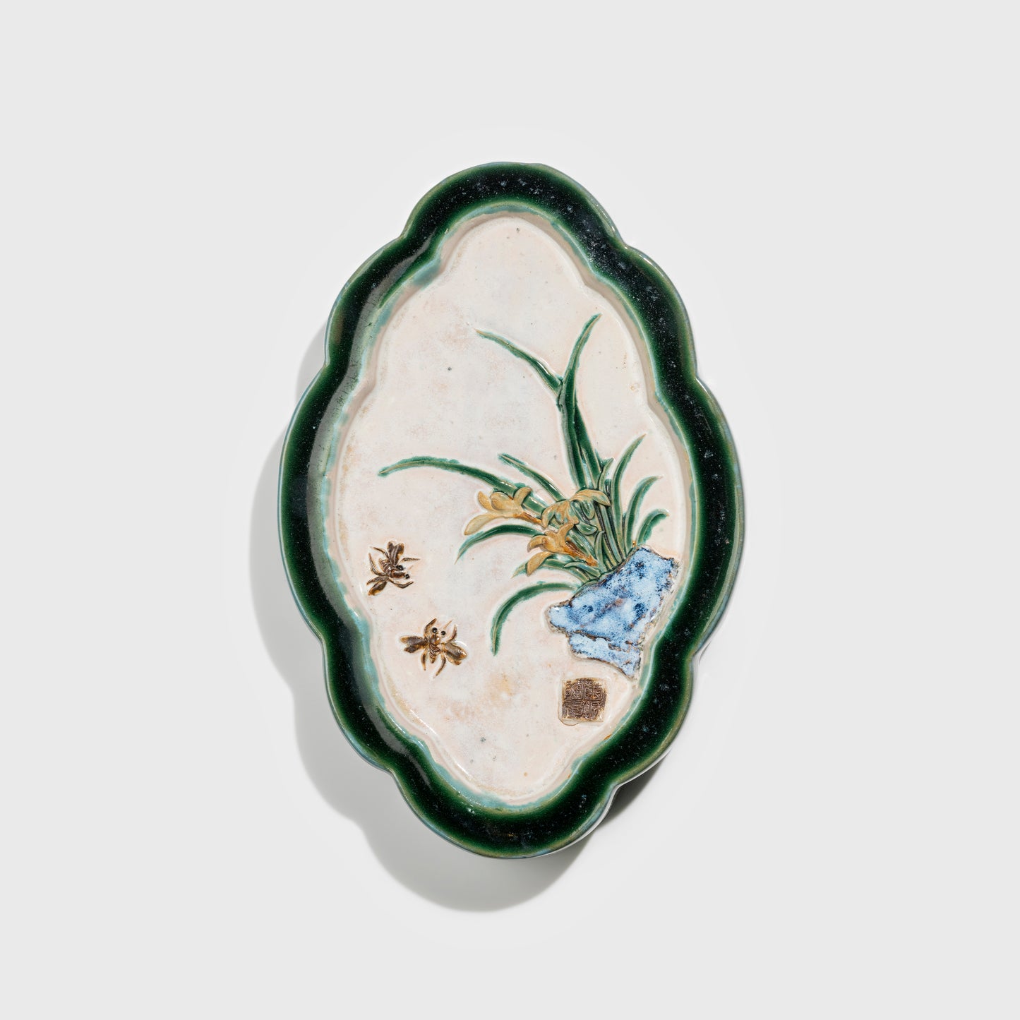 Shiwan handcrafted ceramic wall art depicting orchid, traditional Chinese hanging vase with Cantonese glaze technique.