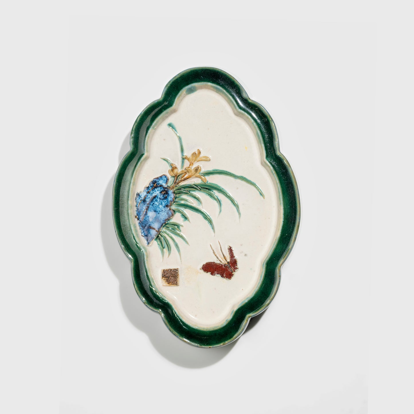 Shiwan handcrafted ceramic wall art depicting orchid, traditional Chinese hanging vase with Cantonese glaze technique.