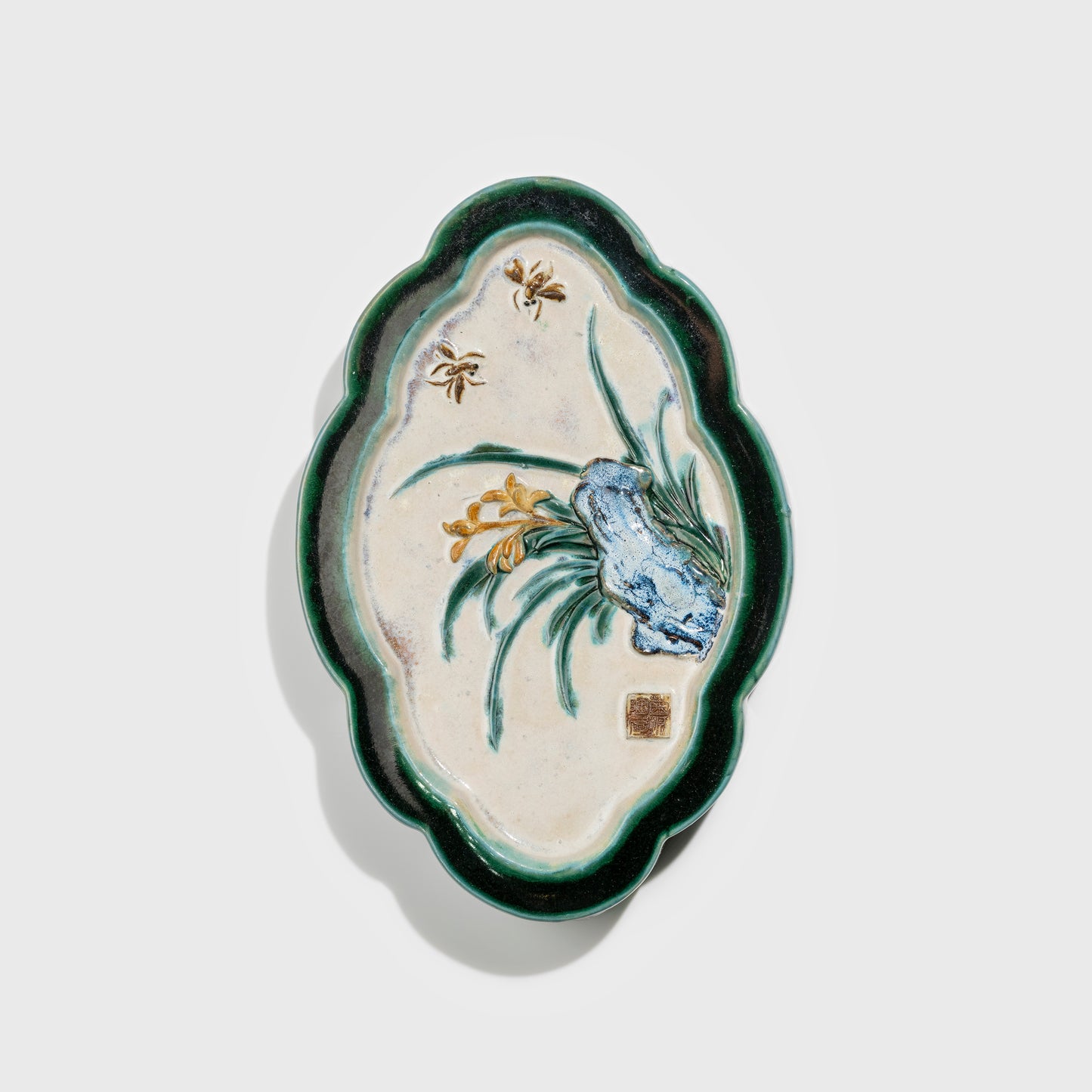 Shiwan handcrafted ceramic wall art depicting orchid, traditional Chinese hanging vase with Cantonese glaze technique.