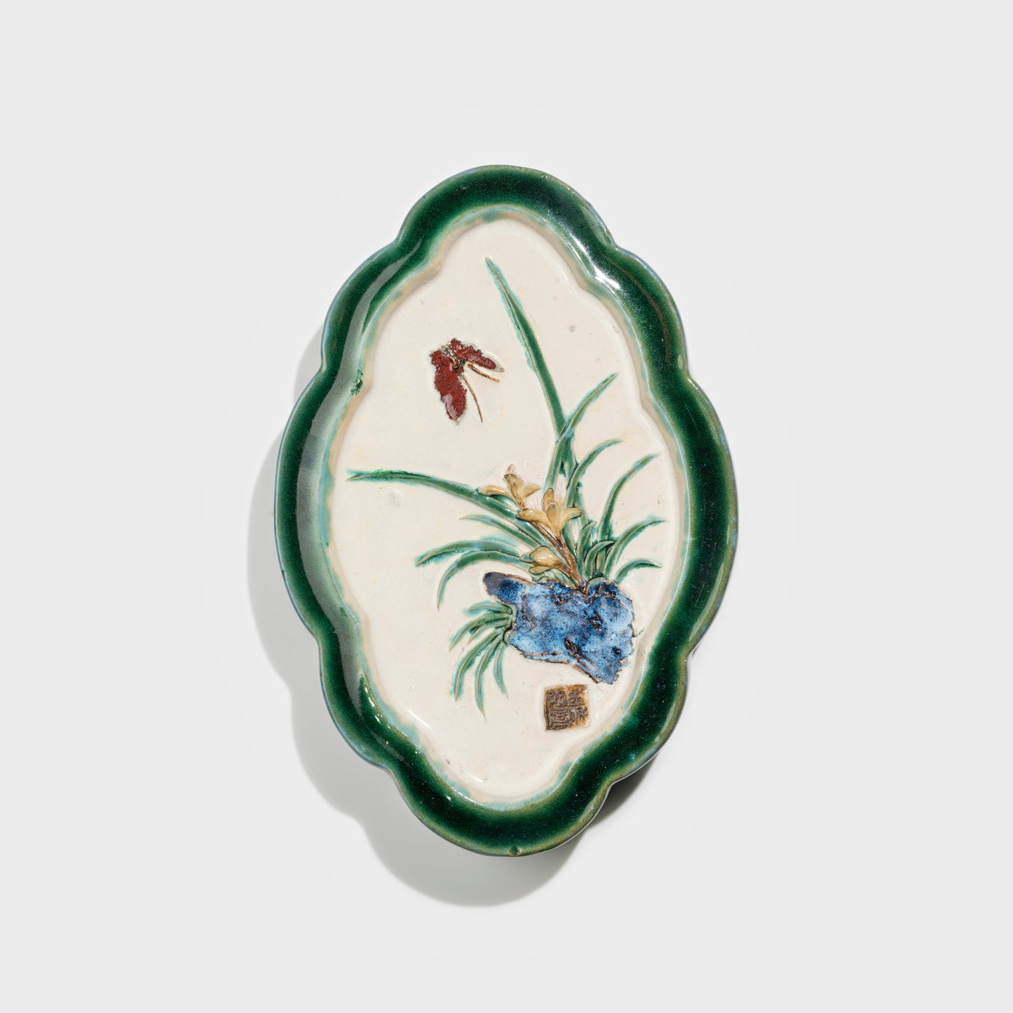 Shiwan handcrafted ceramic wall art depicting orchid, traditional Chinese hanging vase with Cantonese glaze technique.