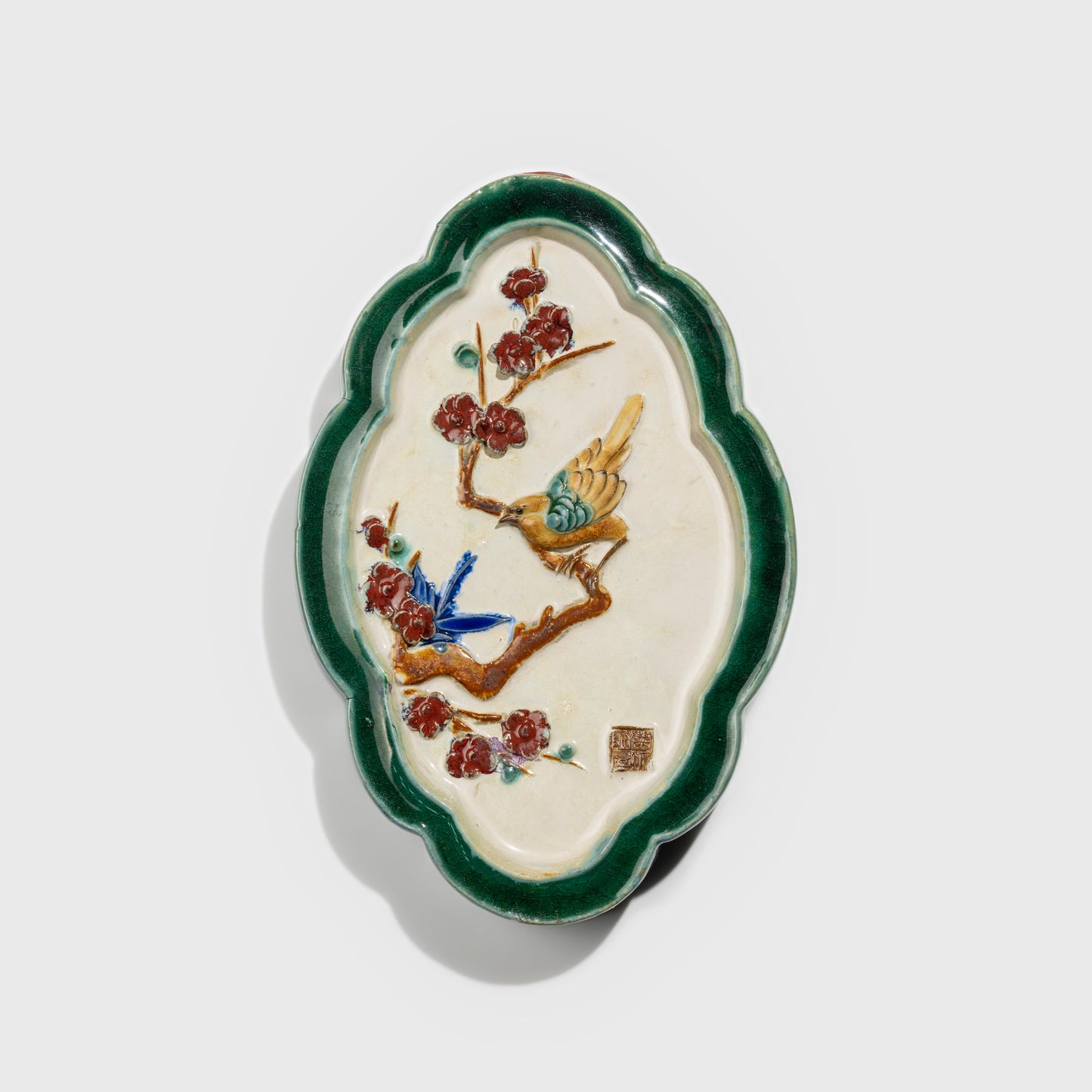 Shiwan handcrafted ceramic wall art depicting plum blossoms, traditional Chinese hanging vase with Cantonese glaze technique.