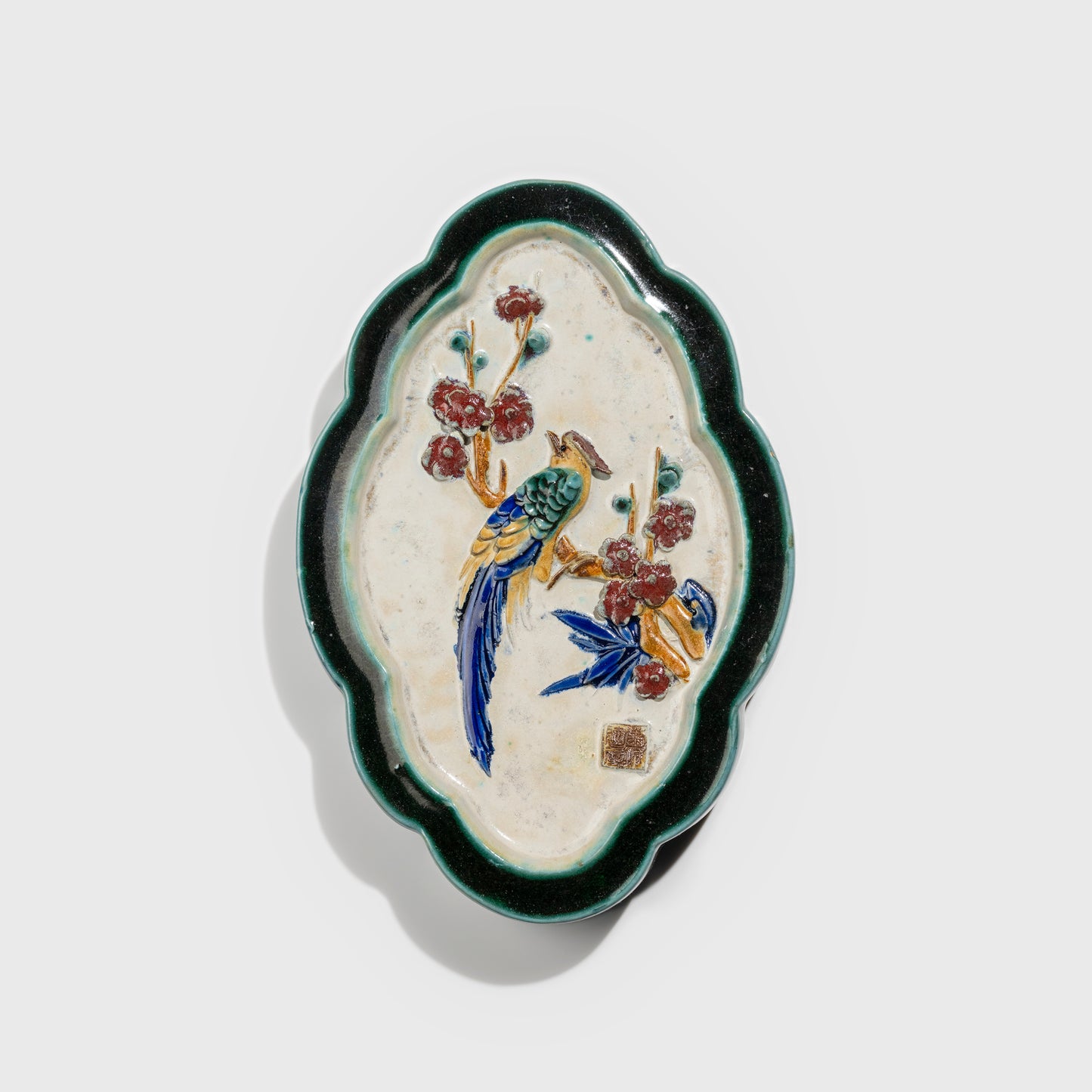 Shiwan handcrafted ceramic wall art depicting plum blossoms, traditional Chinese hanging vase with Cantonese glaze technique.