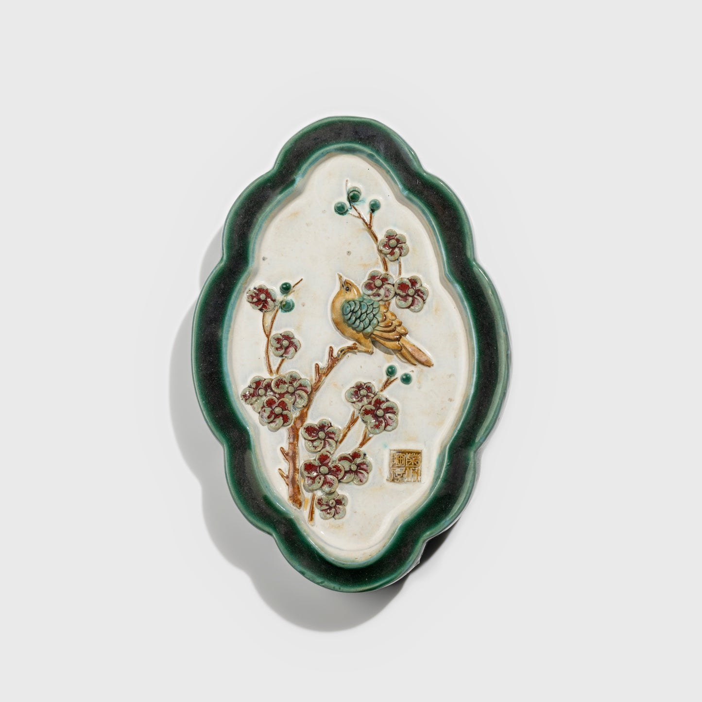 Shiwan handcrafted ceramic wall art depicting plum blossoms, traditional Chinese hanging vase with Cantonese glaze technique.