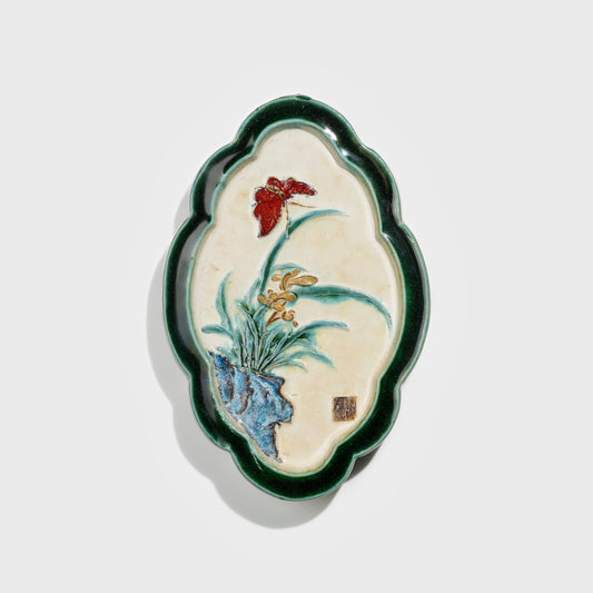 Shiwan handcrafted ceramic wall art depicting orchid, traditional Chinese hanging vase with Cantonese glaze technique.