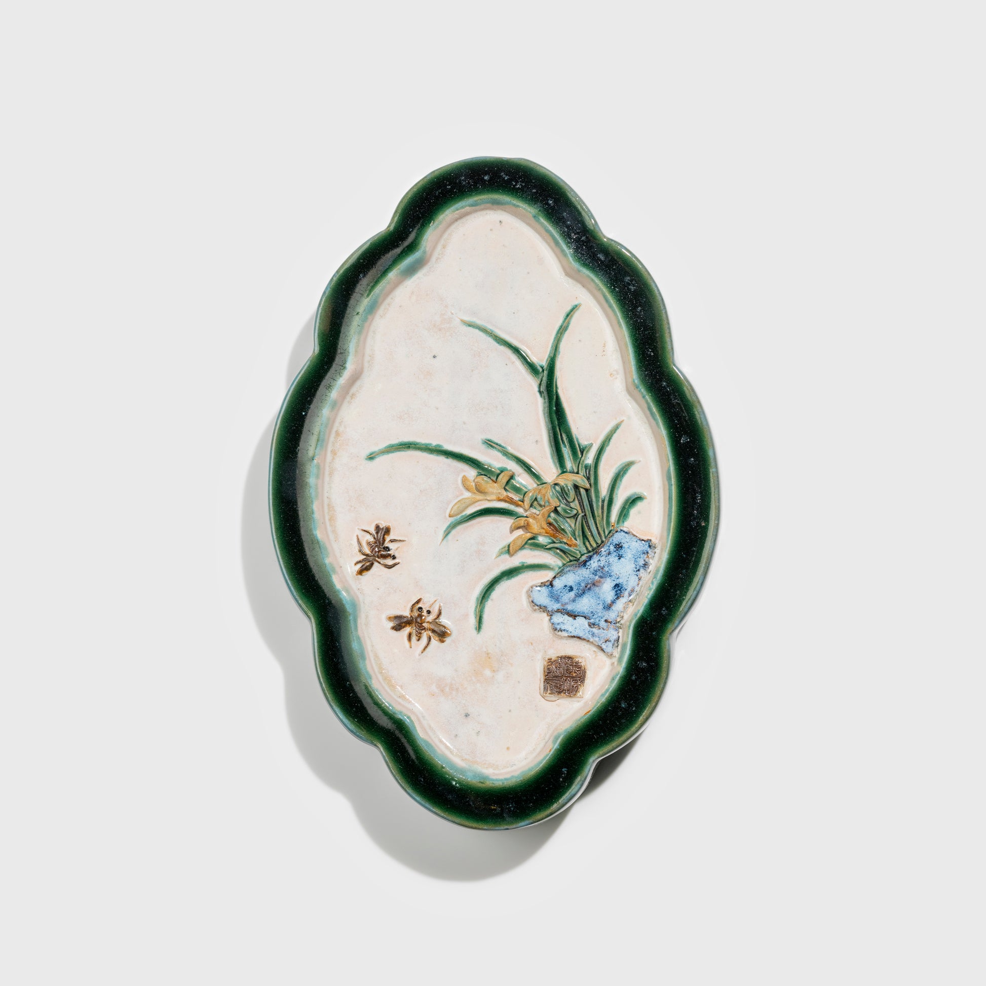 Shiwan handcrafted ceramic wall art depicting orchid, traditional Chinese hanging vase with Cantonese glaze technique.
