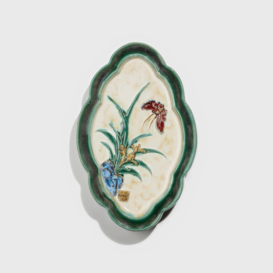 Shiwan handcrafted ceramic wall art depicting orchid, traditional Chinese hanging vase with Cantonese glaze technique.
