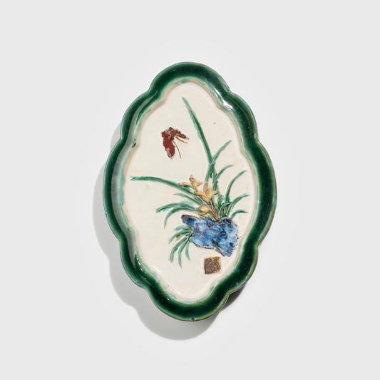 Shiwan handcrafted ceramic wall art depicting orchid, traditional Chinese hanging vase with Cantonese glaze technique.