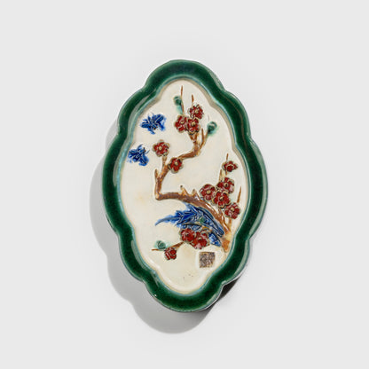 Shiwan handcrafted ceramic wall art depicting plum blossoms, traditional Chinese hanging vase with Cantonese glaze technique.