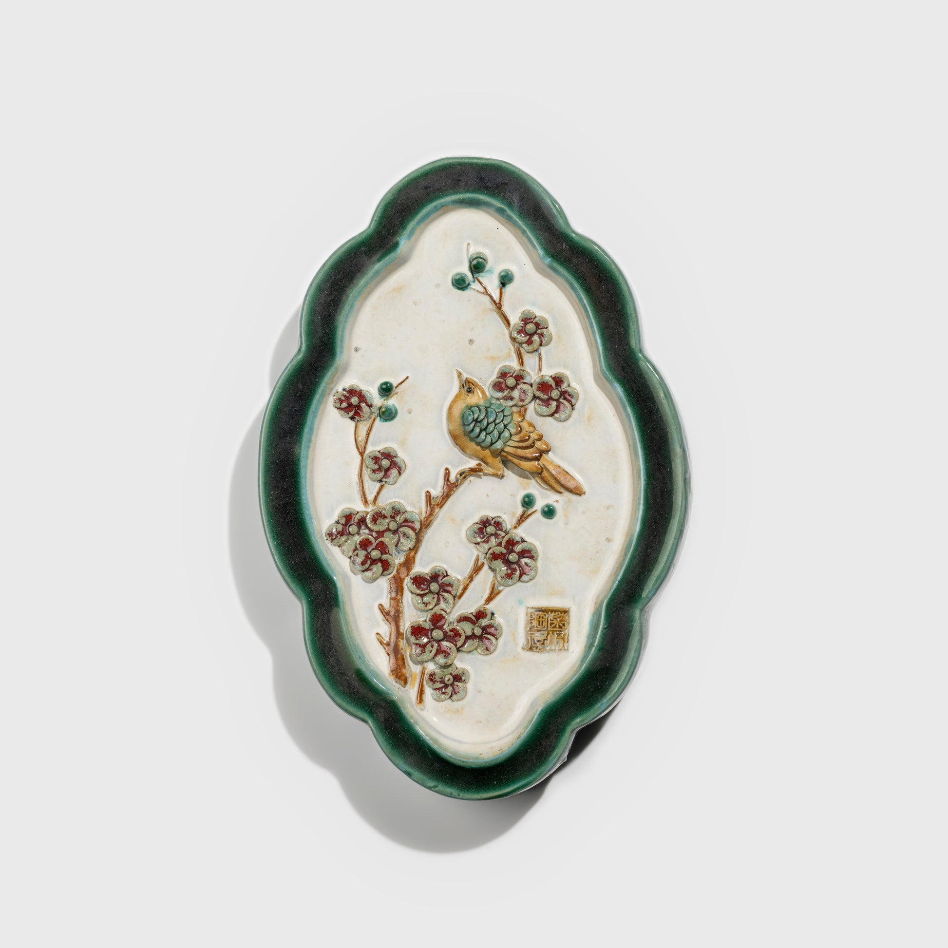 Shiwan handcrafted ceramic wall art depicting plum blossoms, traditional Chinese hanging vase with Cantonese glaze technique.