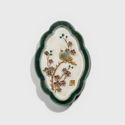 Shiwan handcrafted ceramic wall art depicting plum blossoms, traditional Chinese hanging vase with Cantonese glaze technique.