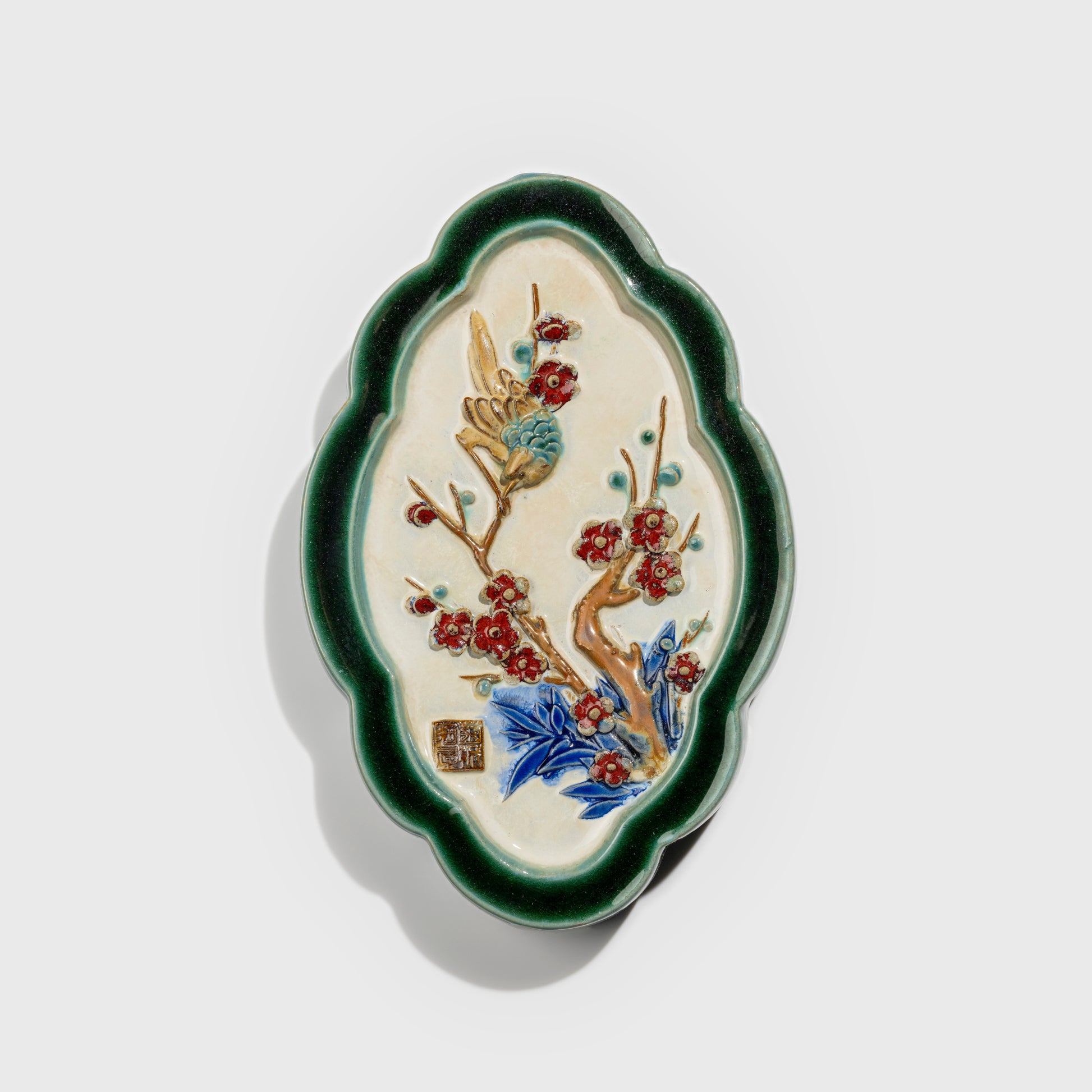 Shiwan handcrafted ceramic wall art depicting plum blossoms, traditional Chinese hanging vase with Cantonese glaze technique.