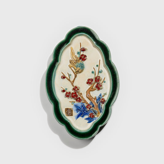 Shiwan handcrafted ceramic wall art depicting plum blossoms, traditional Chinese hanging vase with Cantonese glaze technique.