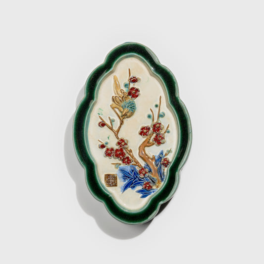 Shiwan handcrafted ceramic wall art depicting plum blossoms, traditional Chinese hanging vase with Cantonese glaze technique.